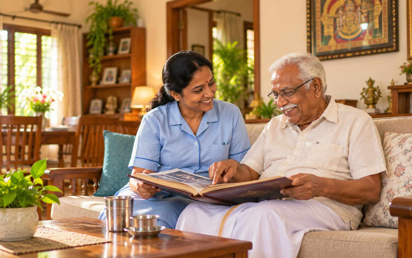 A caregiver and an elderly man smiling over a family photo album at home